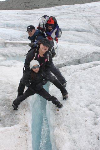 Oh family standing across a crevasse