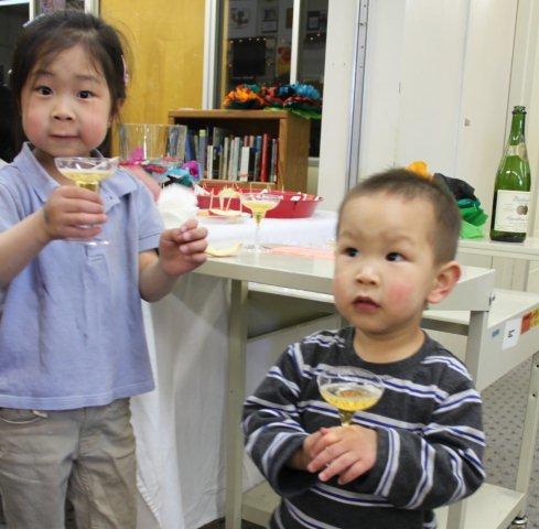 Kyra and Ethan making a toast with a kid-friendly champagne glass